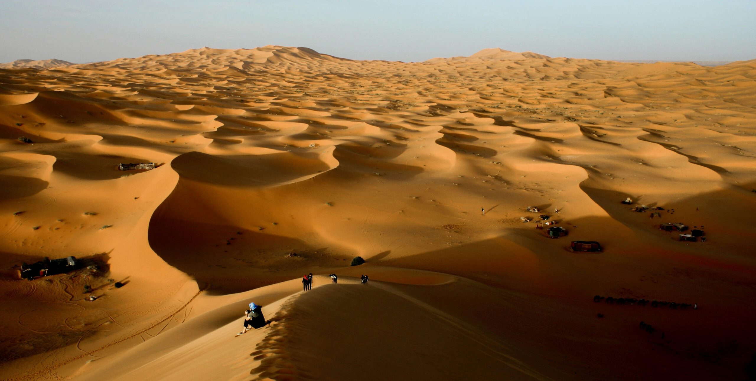 Swedish travellers exploring Morocco on a guided desert tour with camels in Merzouga.
